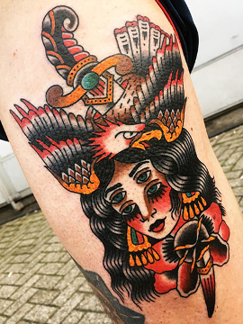 Traditional tattoo of girl head, eagle and dagger motifs